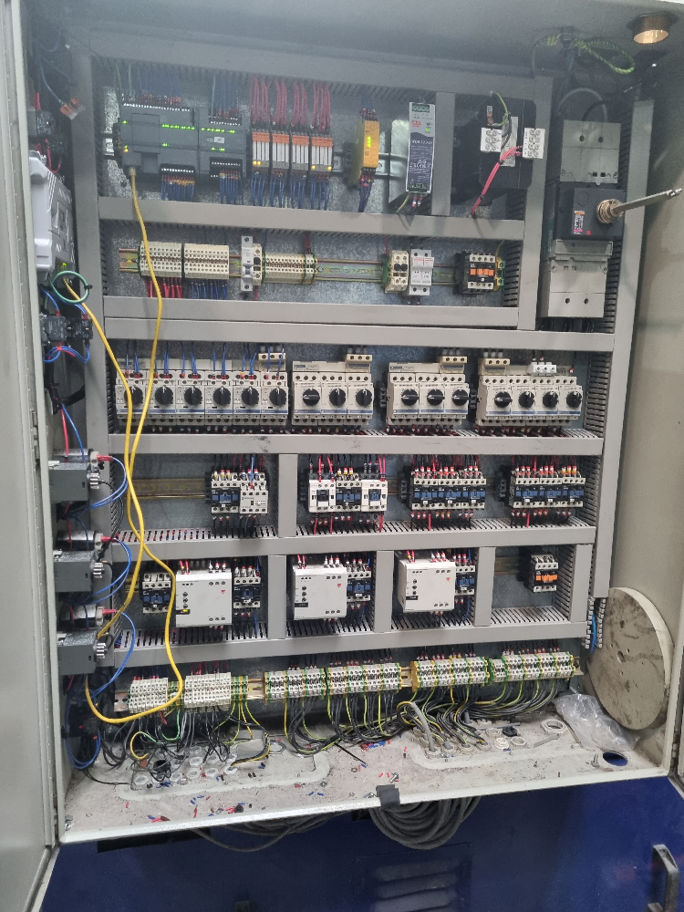 Photo of a control panel looking neat after a rewire with addition of a new PLC, HMI and other components